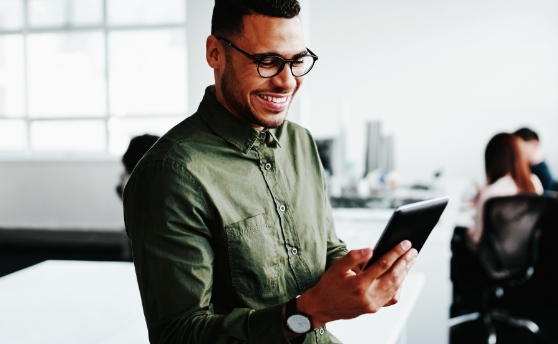 Excited man looking at tablet
